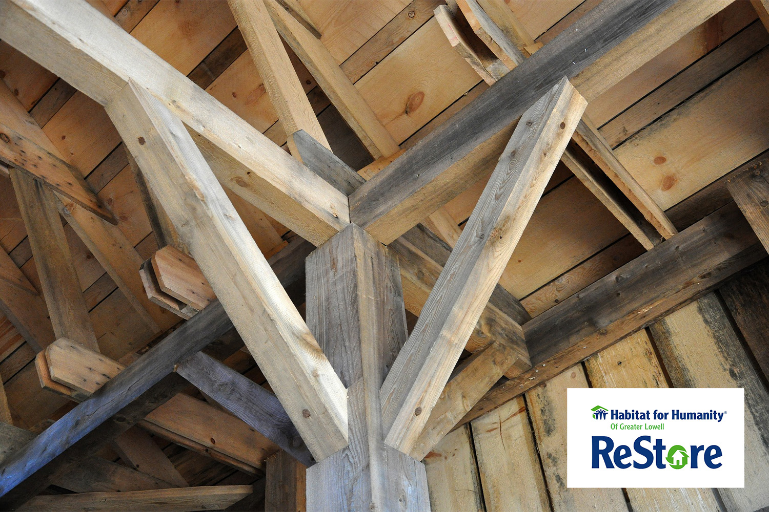 wooden beams with "Habitat for Humanity" logo on the bottom right corner