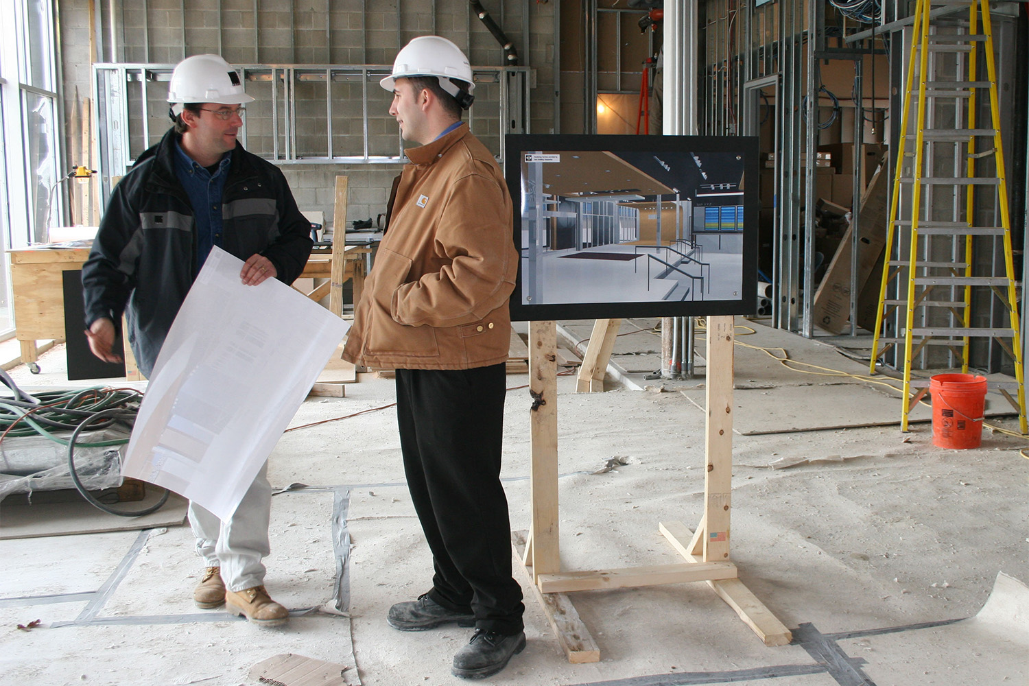 Two Tocci employees using VDC tech at construction site 