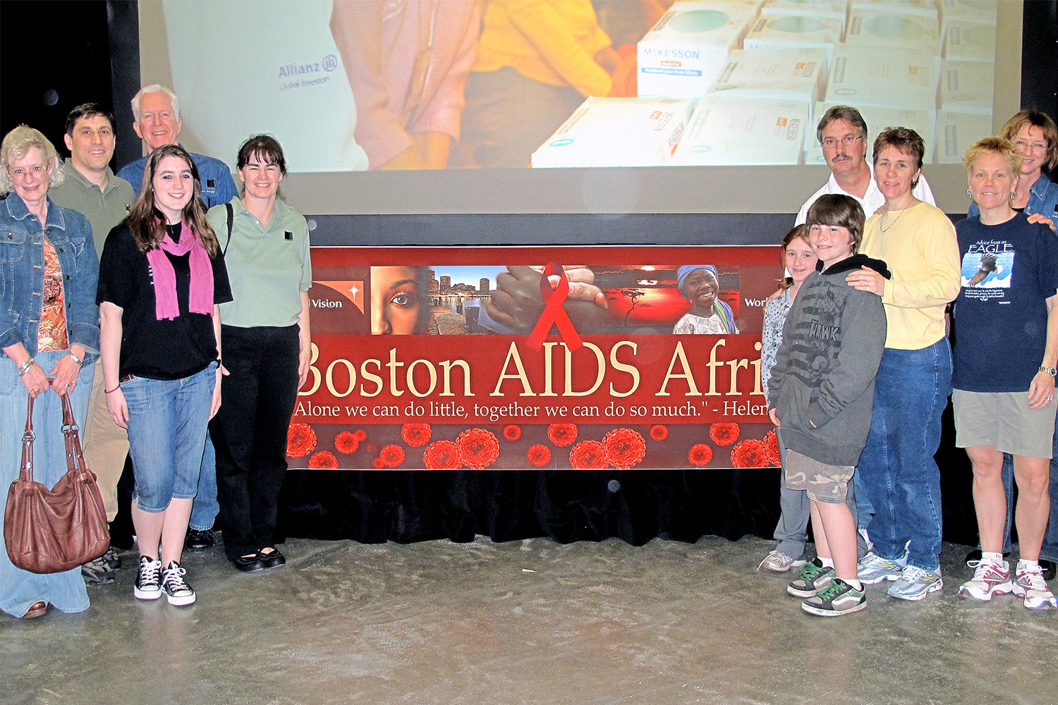 Tocci employees standing by Boston AIDS Africa promotion table 