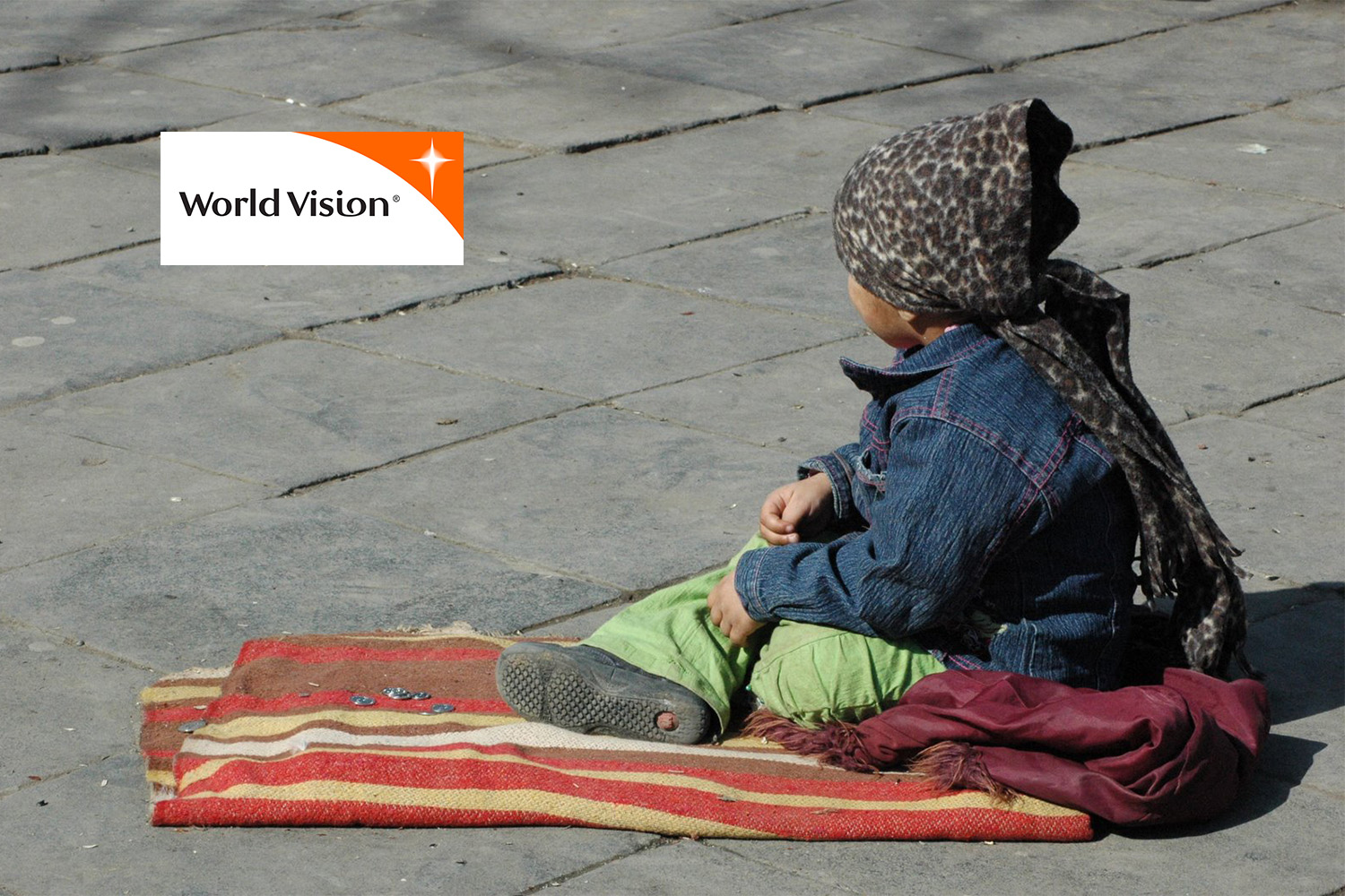 Georgian street child laying on blanket 