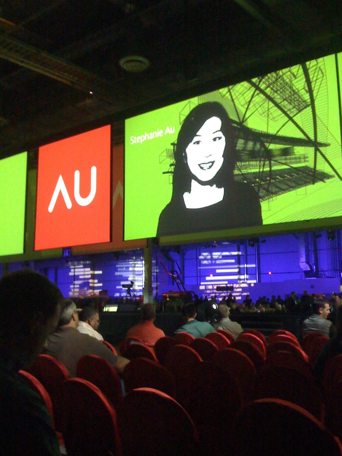 2 monitors, one saying "AU", the other with a woman's face on it 