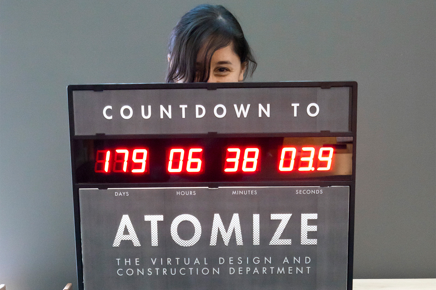 Laura holding up a sign, which counts down time until atomization 
