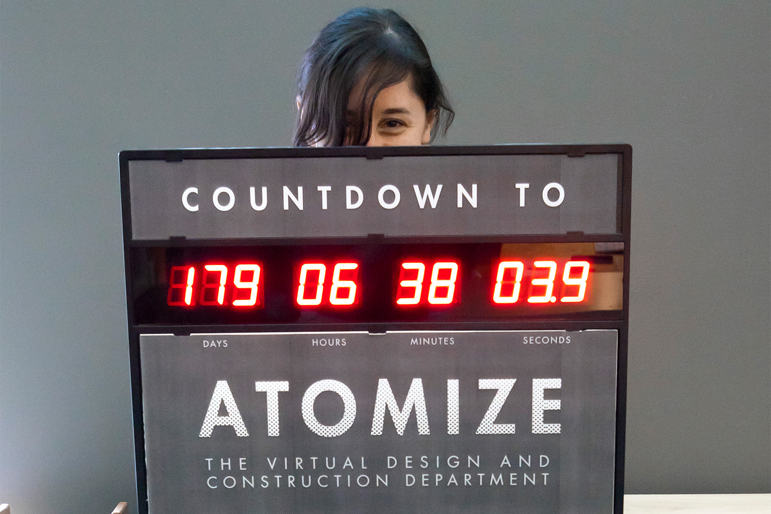 Laura holding up a sign, which counts down time until atomization