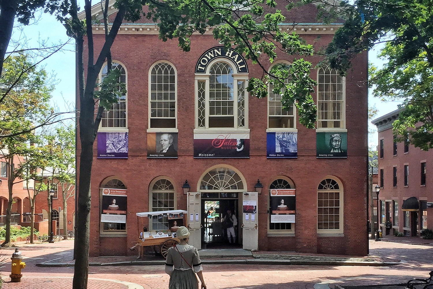 Woman in colonial garb walks towards Town Hall on Boston's Freedom Trail