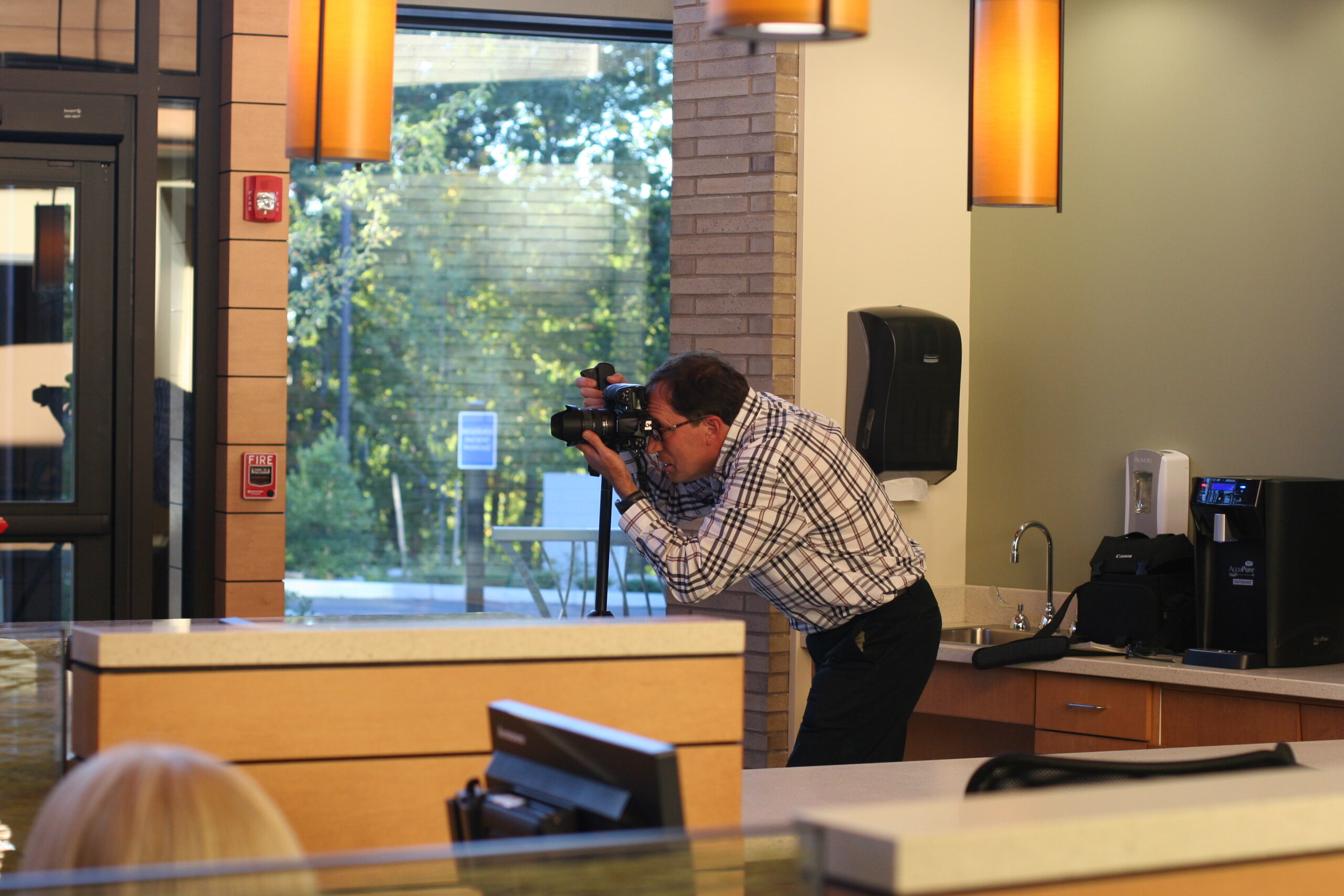 man taking photographs of Marlborough Hospital's interior 