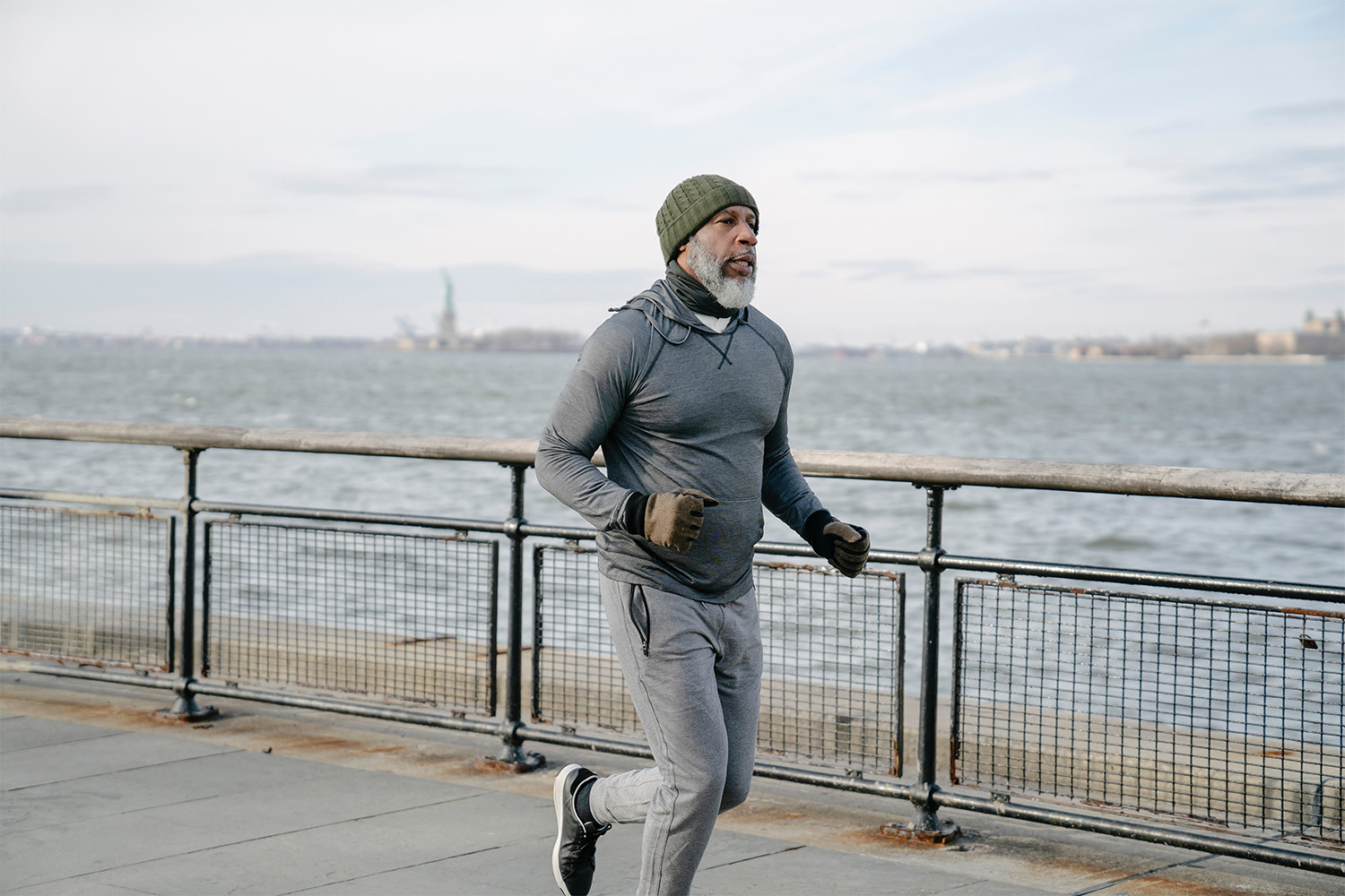 man running across bridge while listening to music