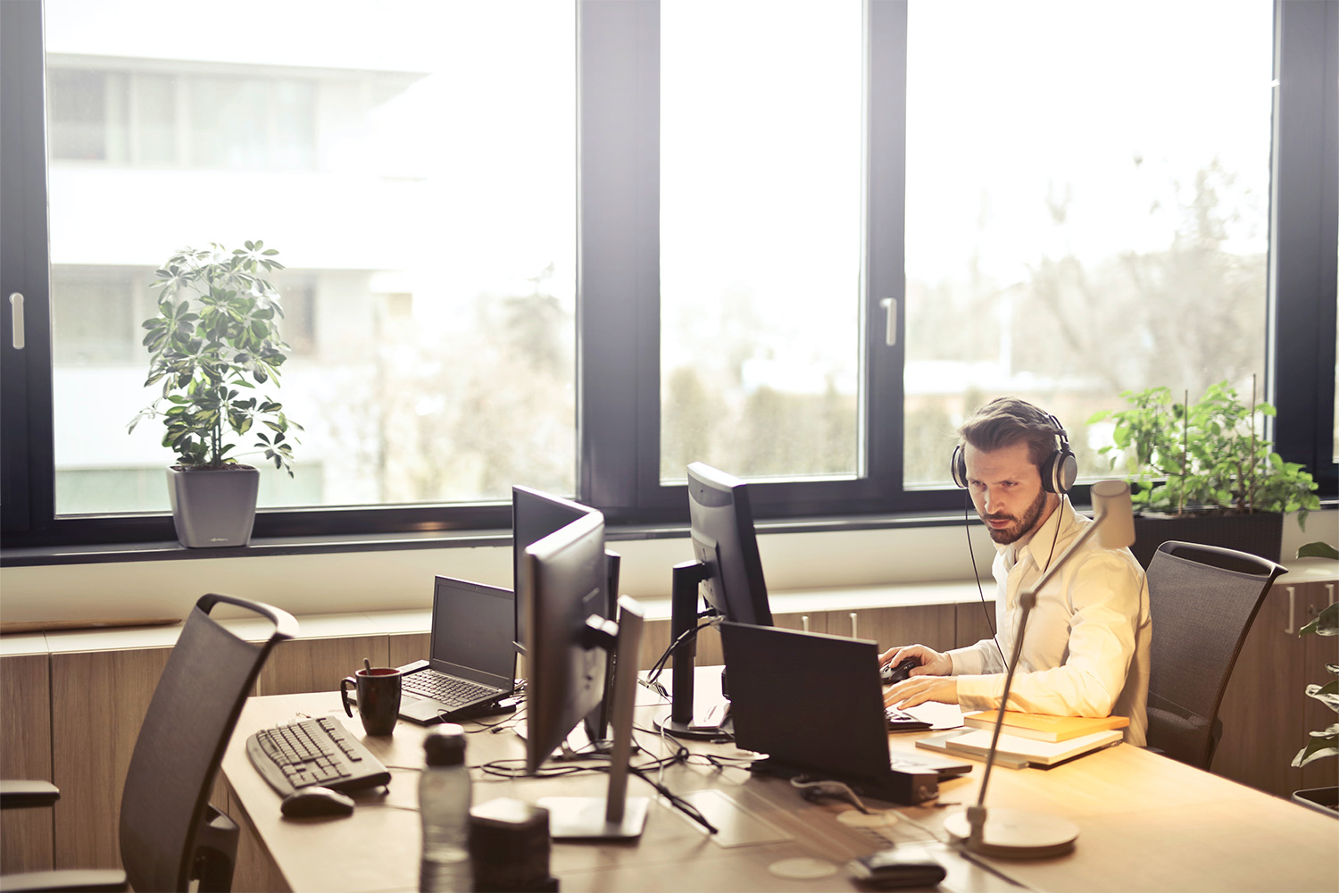 a man wearing headphones in a brightly lit office