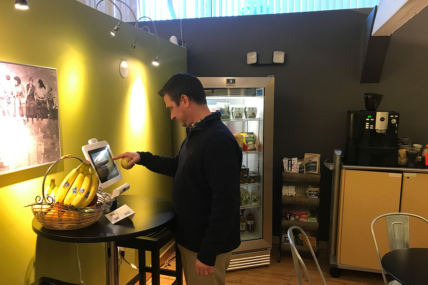 A Tocci staff member puts his information into a point-of-sale system to purchase lunch from the Berkbox console in the cafe.