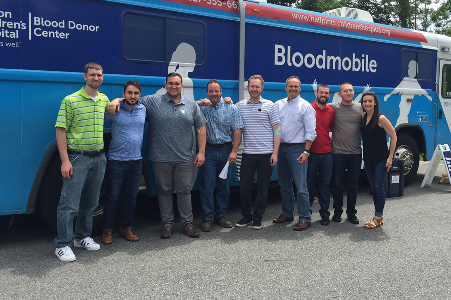 Staff stand in front of Boston Children's Hospital's bloodmobile after donating