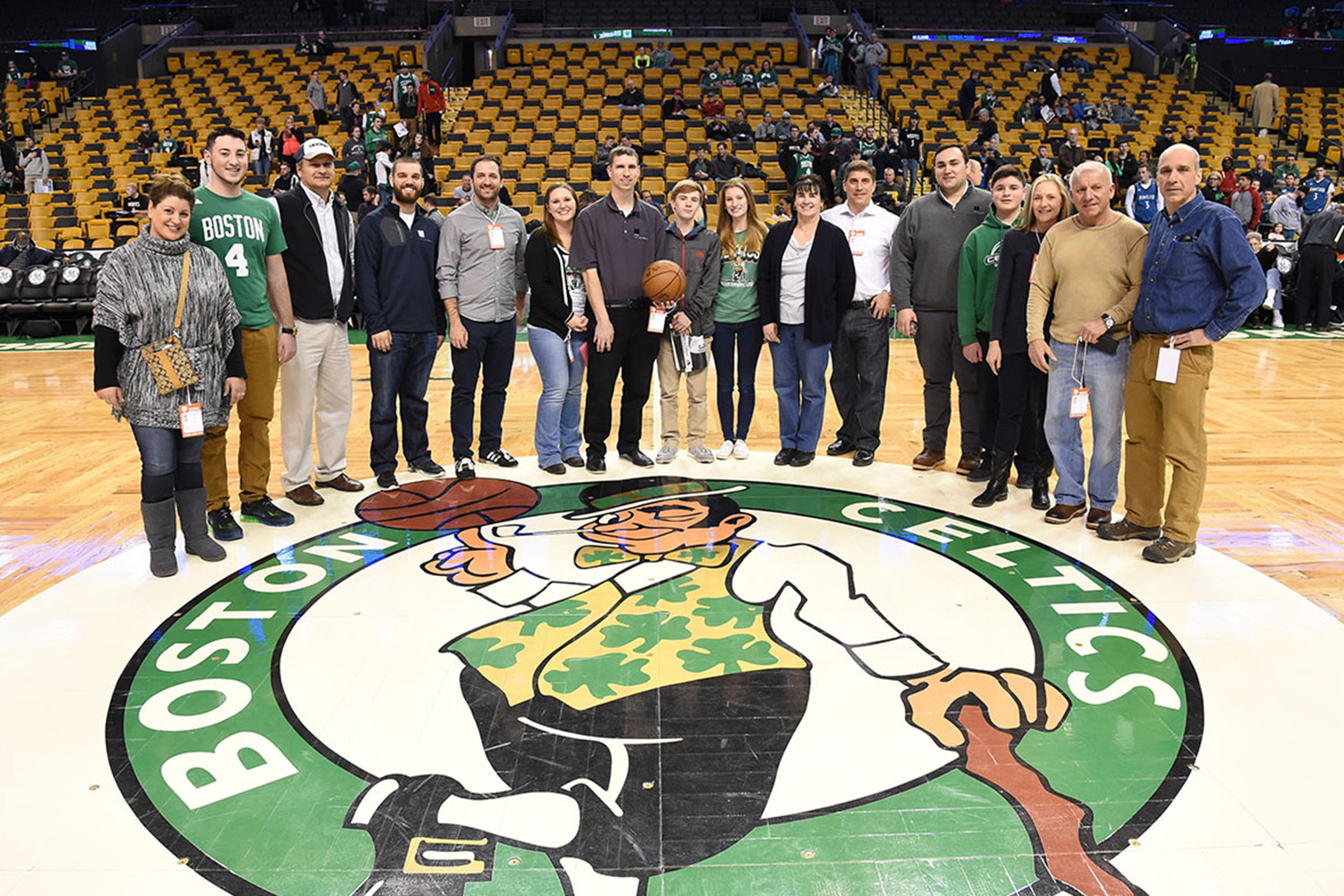 Group of Tocci staff members on the Celtics basketball court after a game
