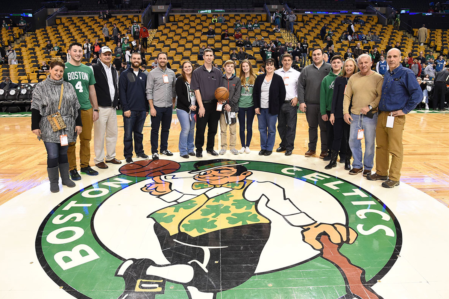 Group of Tocci staff members on the Celtics basketball court after a game
