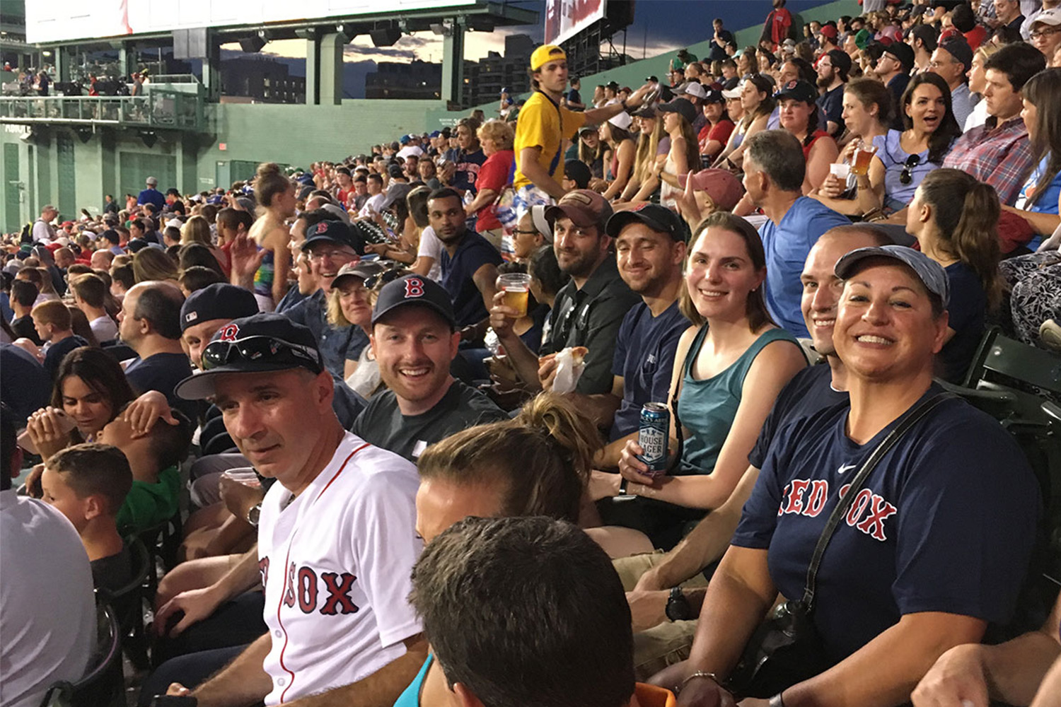 Joe Cavallaro, Tammi Gott, and other staff enjoy a RedSox baseball game