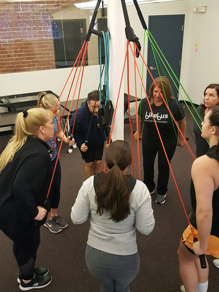 Tammi Gott, Alison Linksy, and others work out during a low-intensity resistance band training