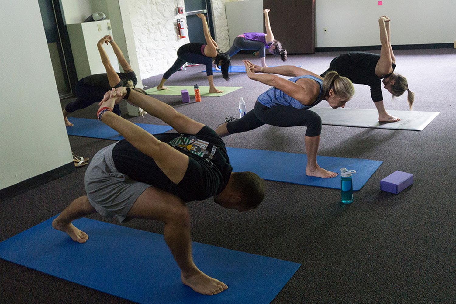 Joe Ferolito and other staff members stretch during a weekly yoga class