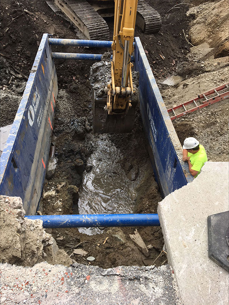 Excavator digging into earth