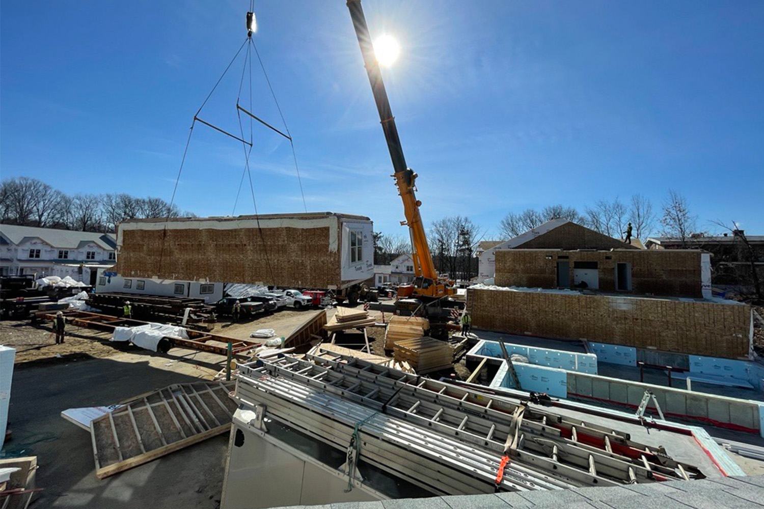 Crane carrying box to correct placement during topping off