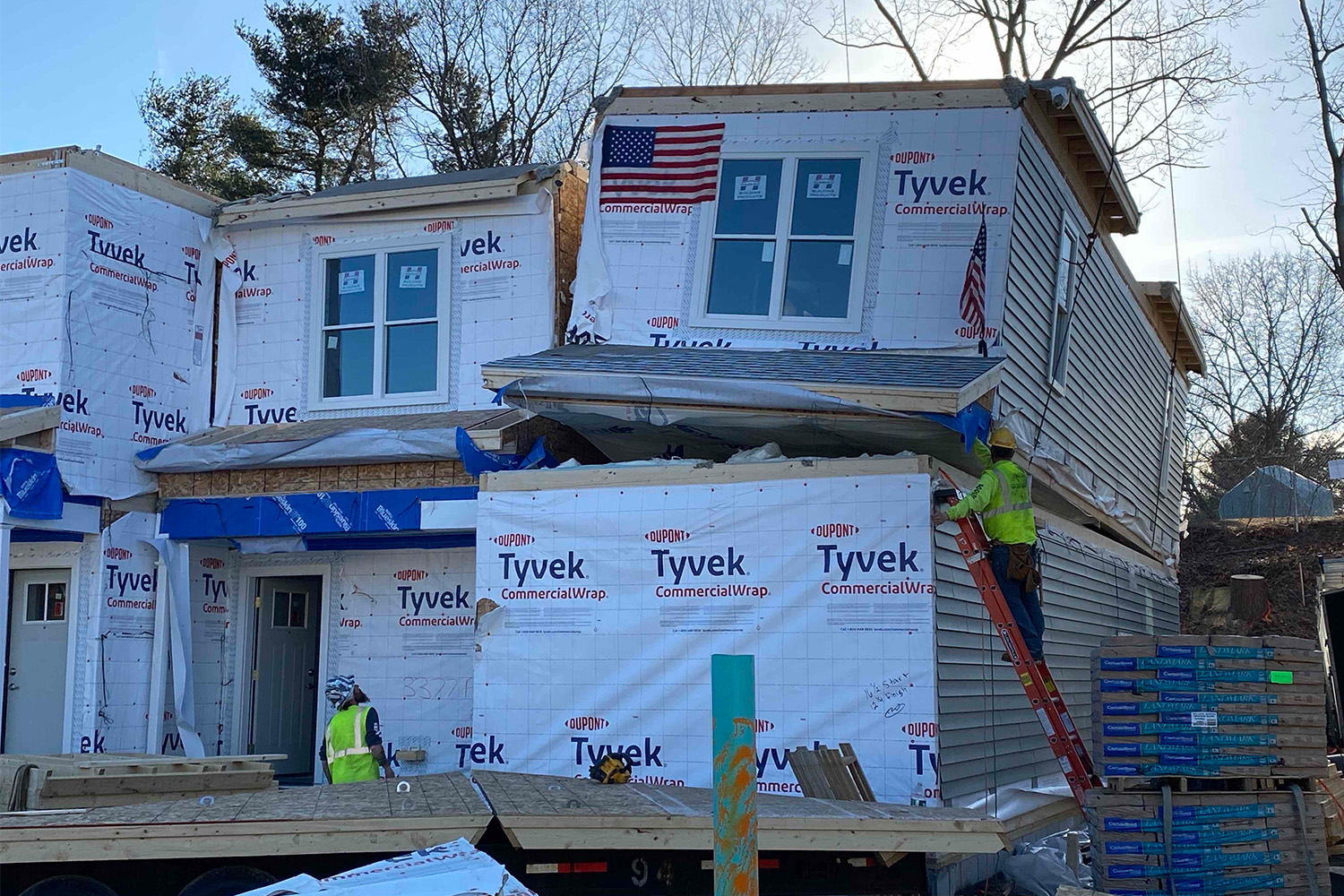 Construction workers near modular box during topping off