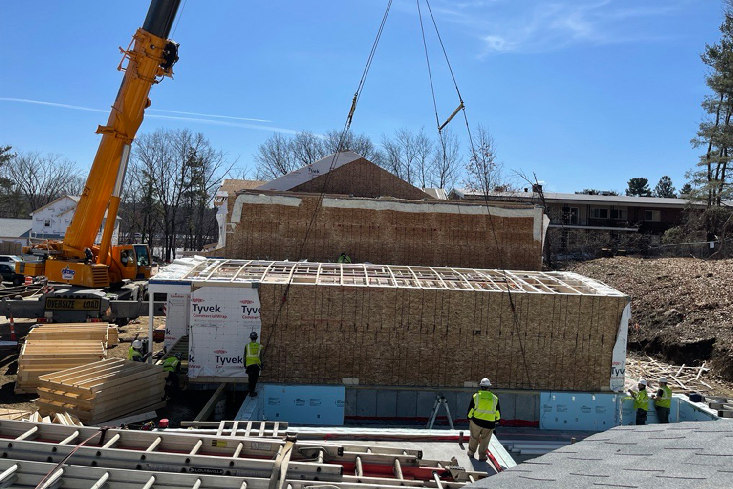 Modular box goes into place during topping off at Natick project site