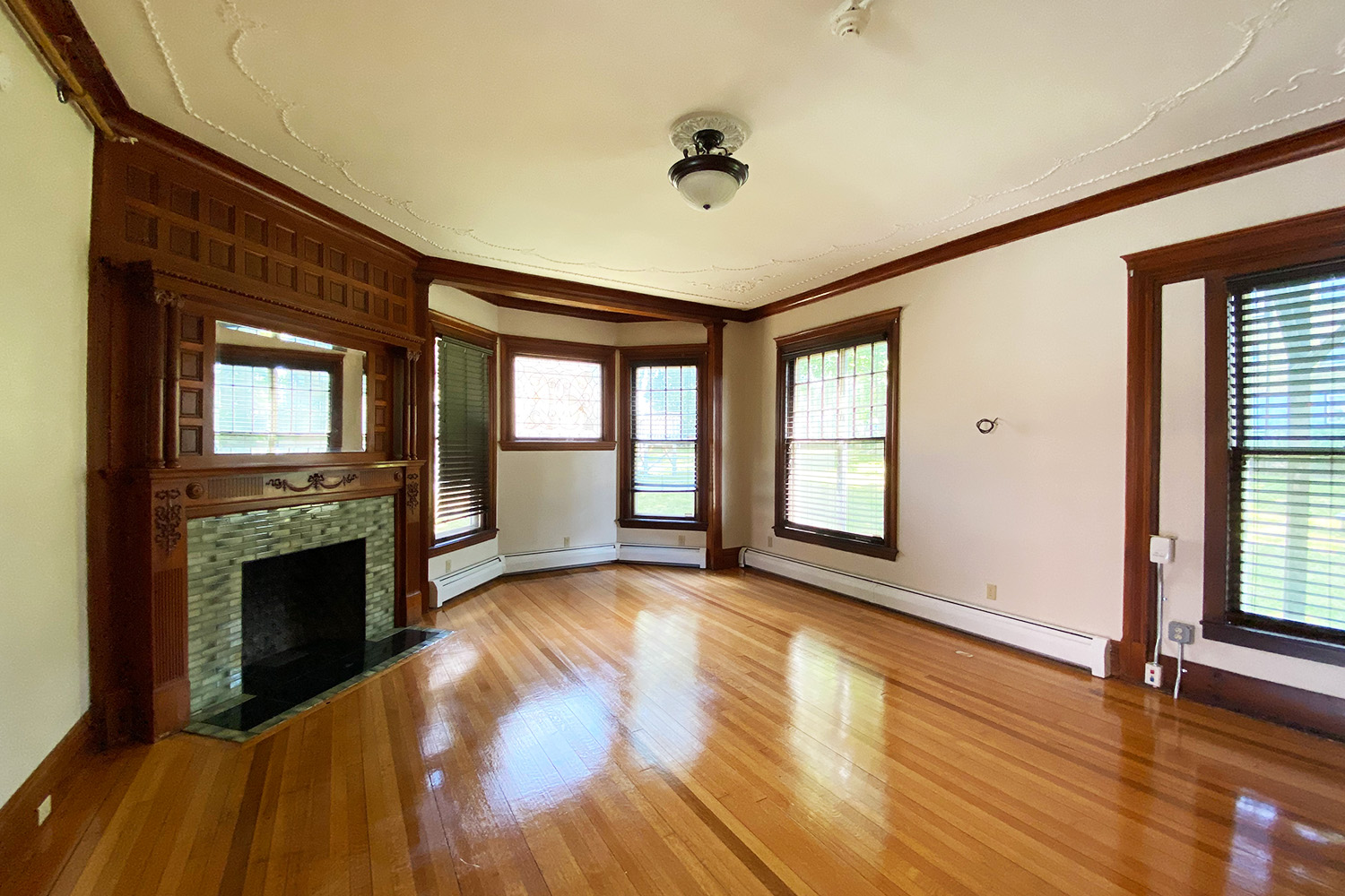 Common room in student dorms with fireplace and wood floors