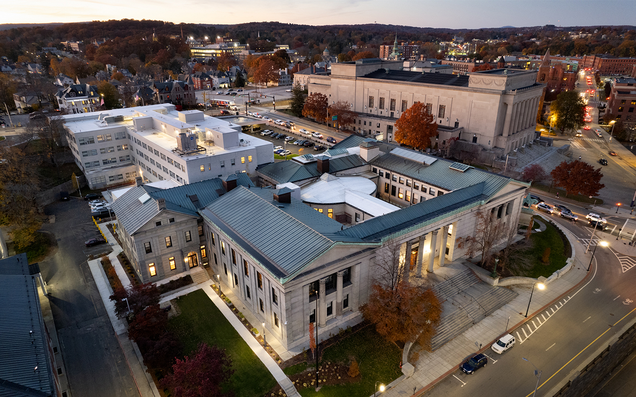 Drone view of front exterior at dusk