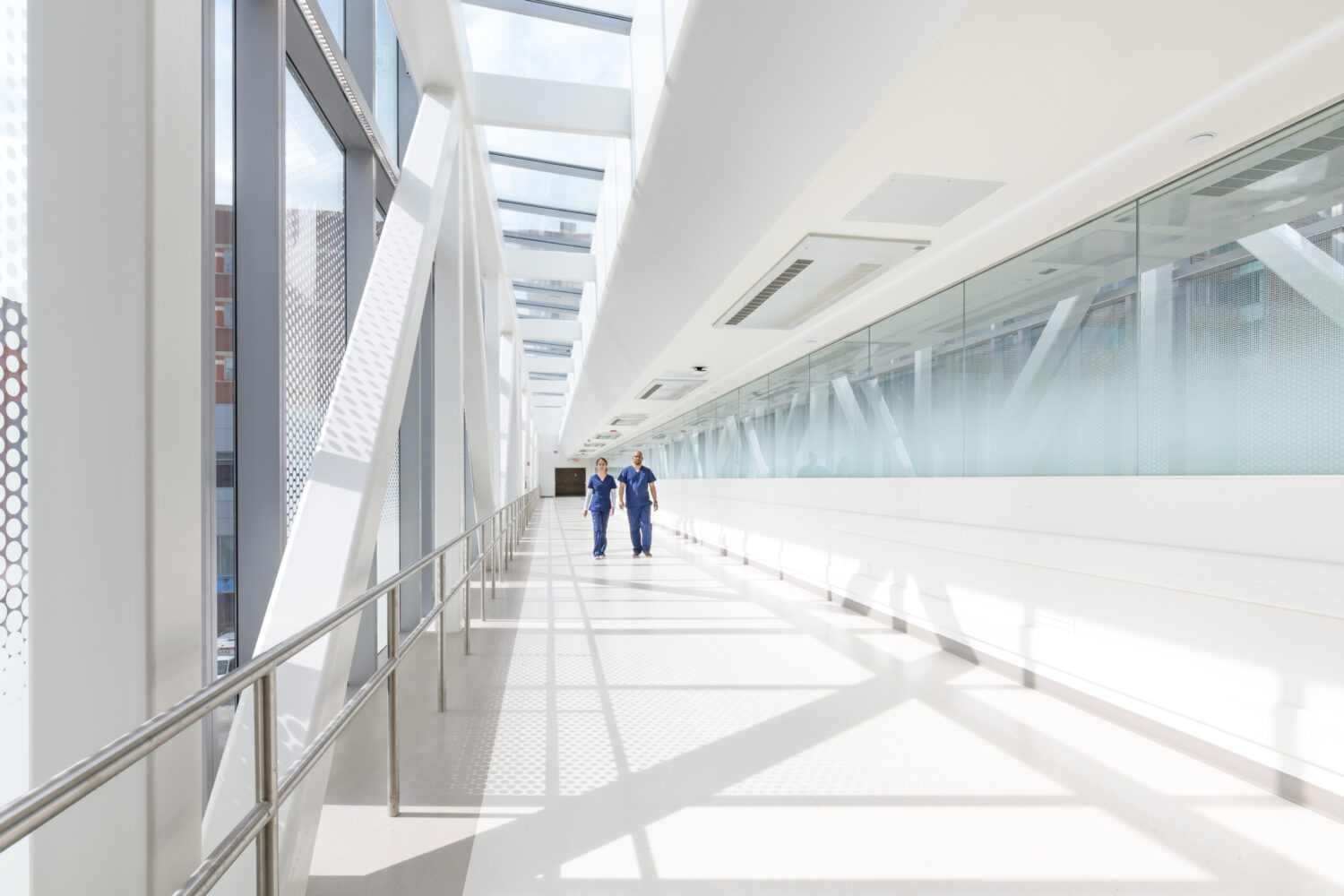 Two nurses walking across BMC skybridge 