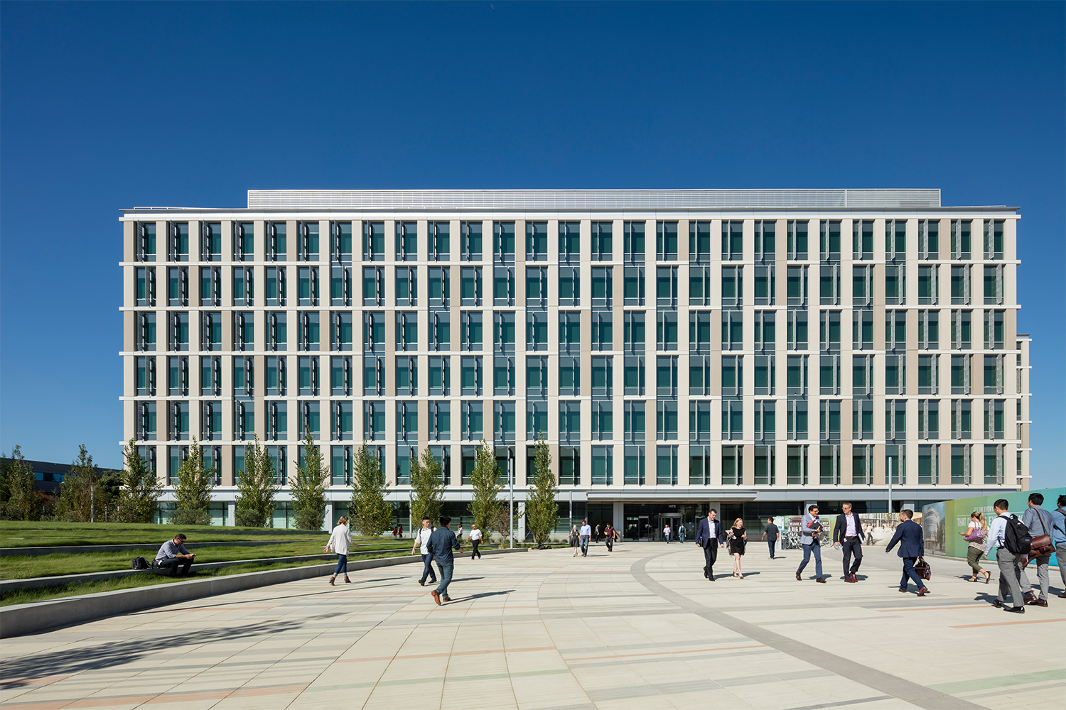 front exterior of Genentech, with people walking in front 