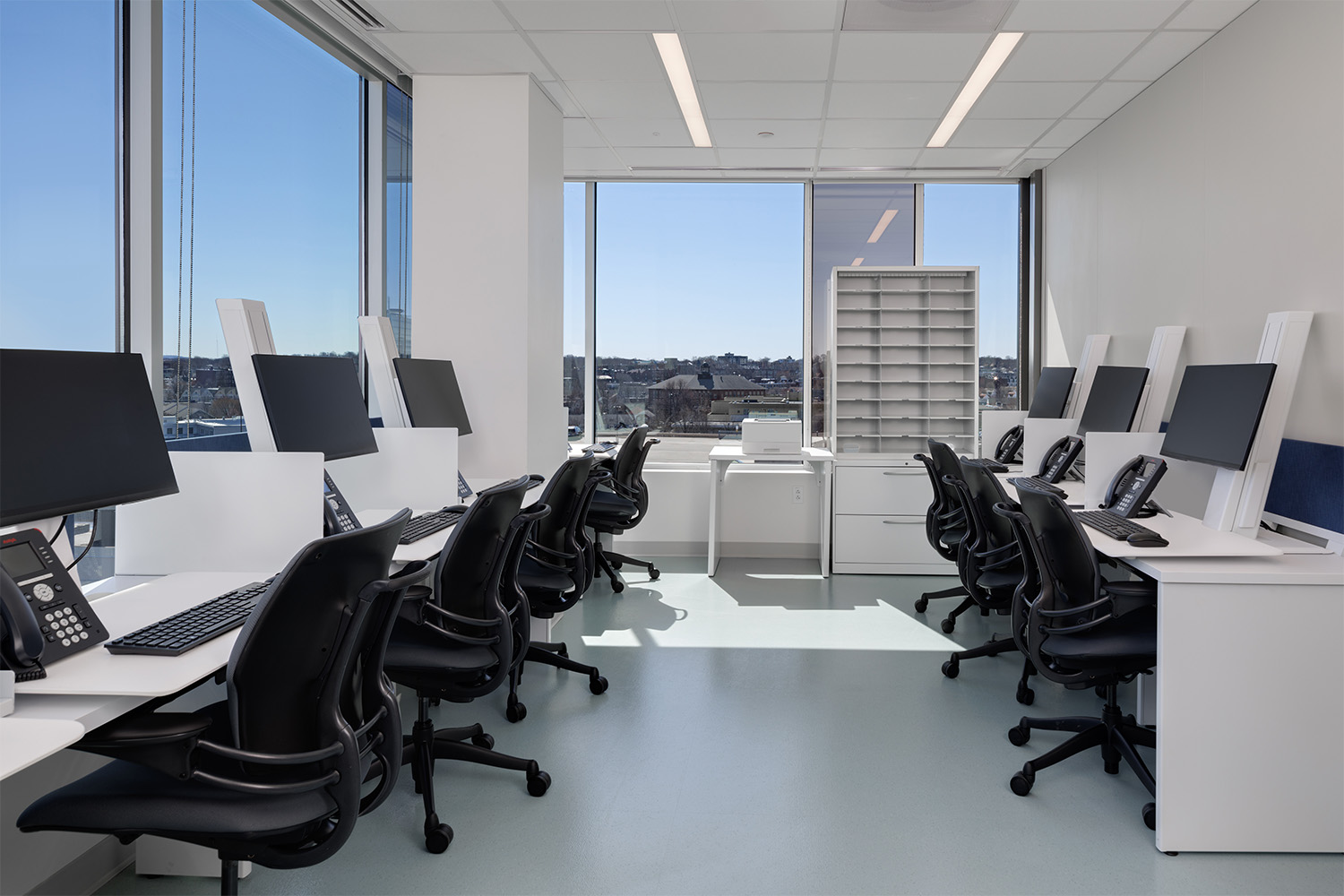 Charting room in hospital in Boston, with wide wall of windows