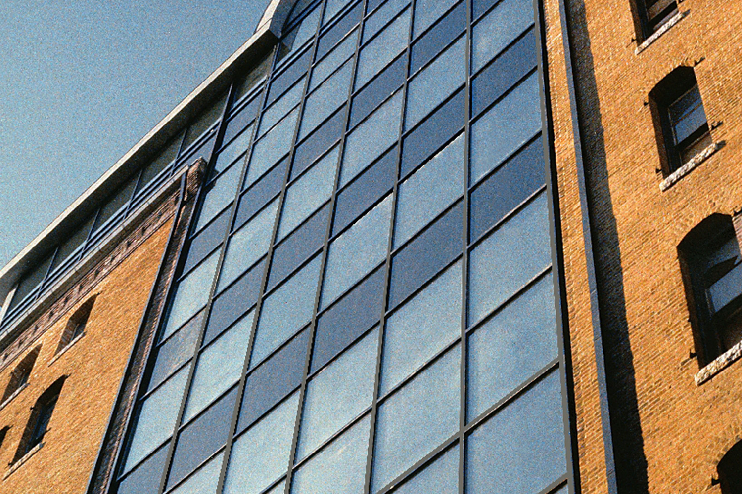 Worm's eye view of massive arched window seen on building exterior
