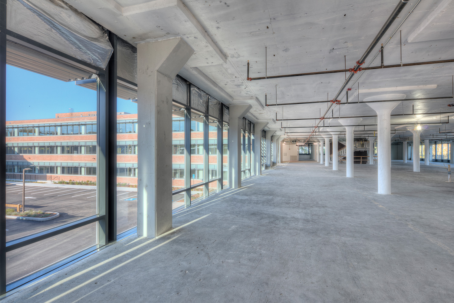 Interior of spacious area with multiple windows in daytime