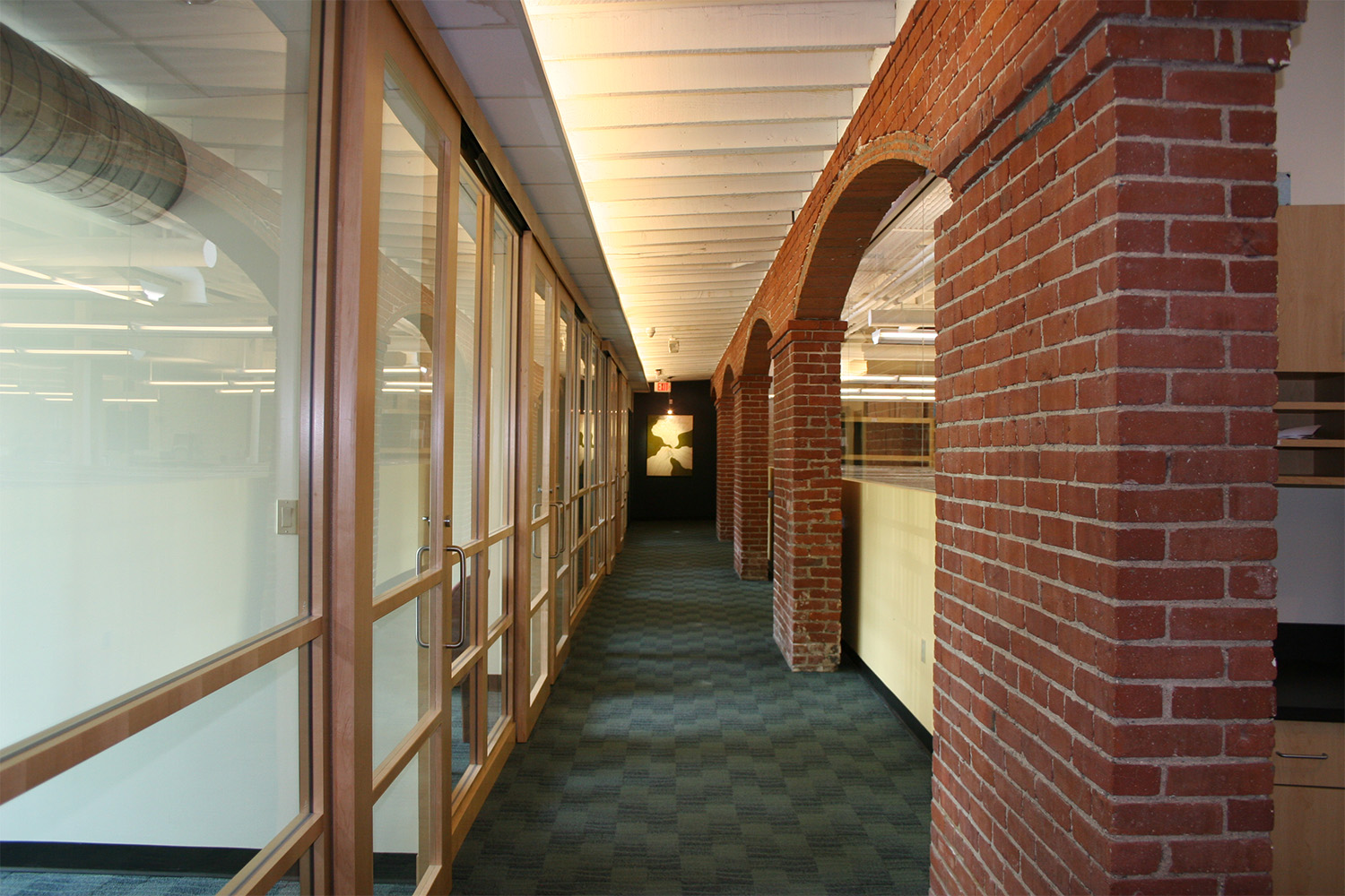 Longview of hallway constructed out of red brick 