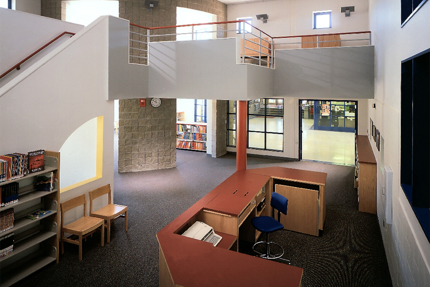 2-level library with help desk, and bookshelves 