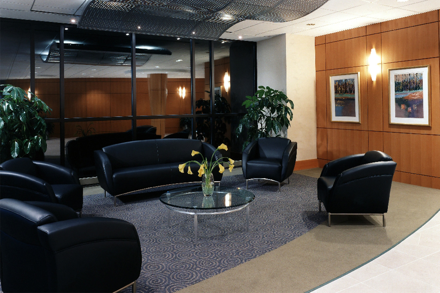 Luxe lobby area with black leather couches and chairs 