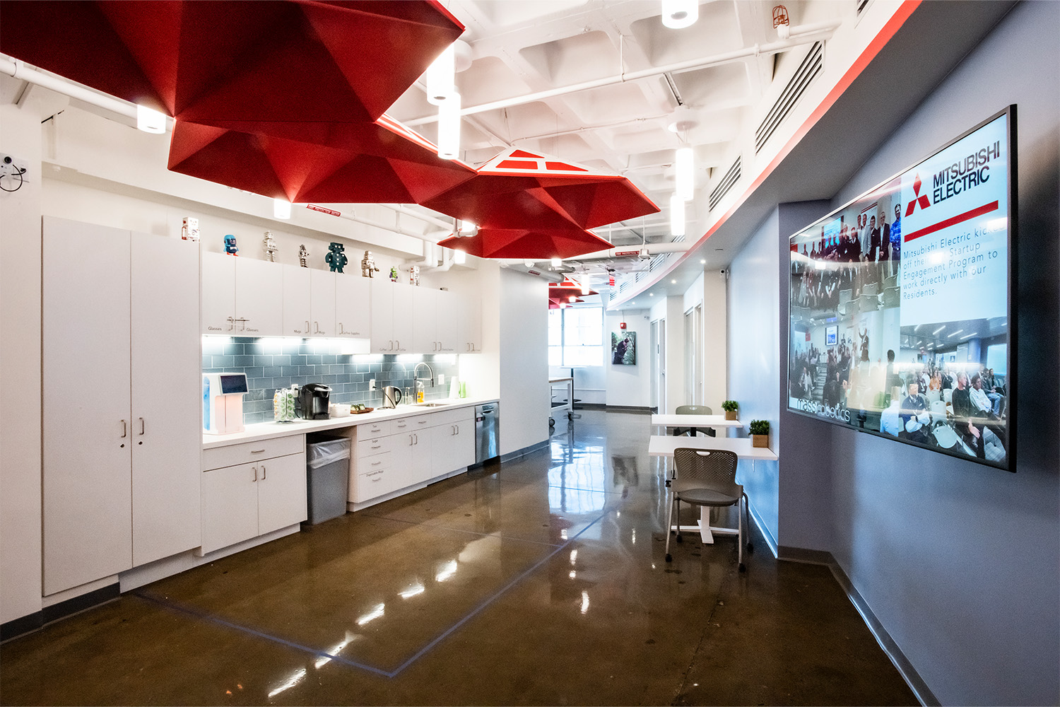 Hallway with red geometric ceiling design