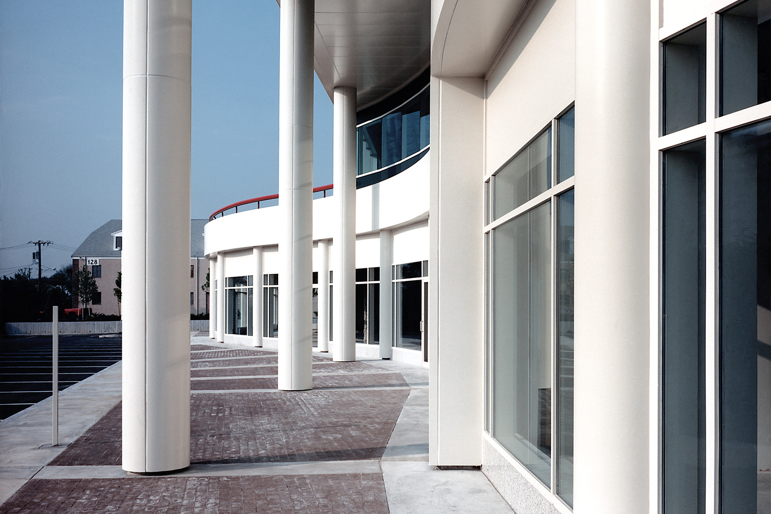 Sidewalk with pillars next to building exterior
