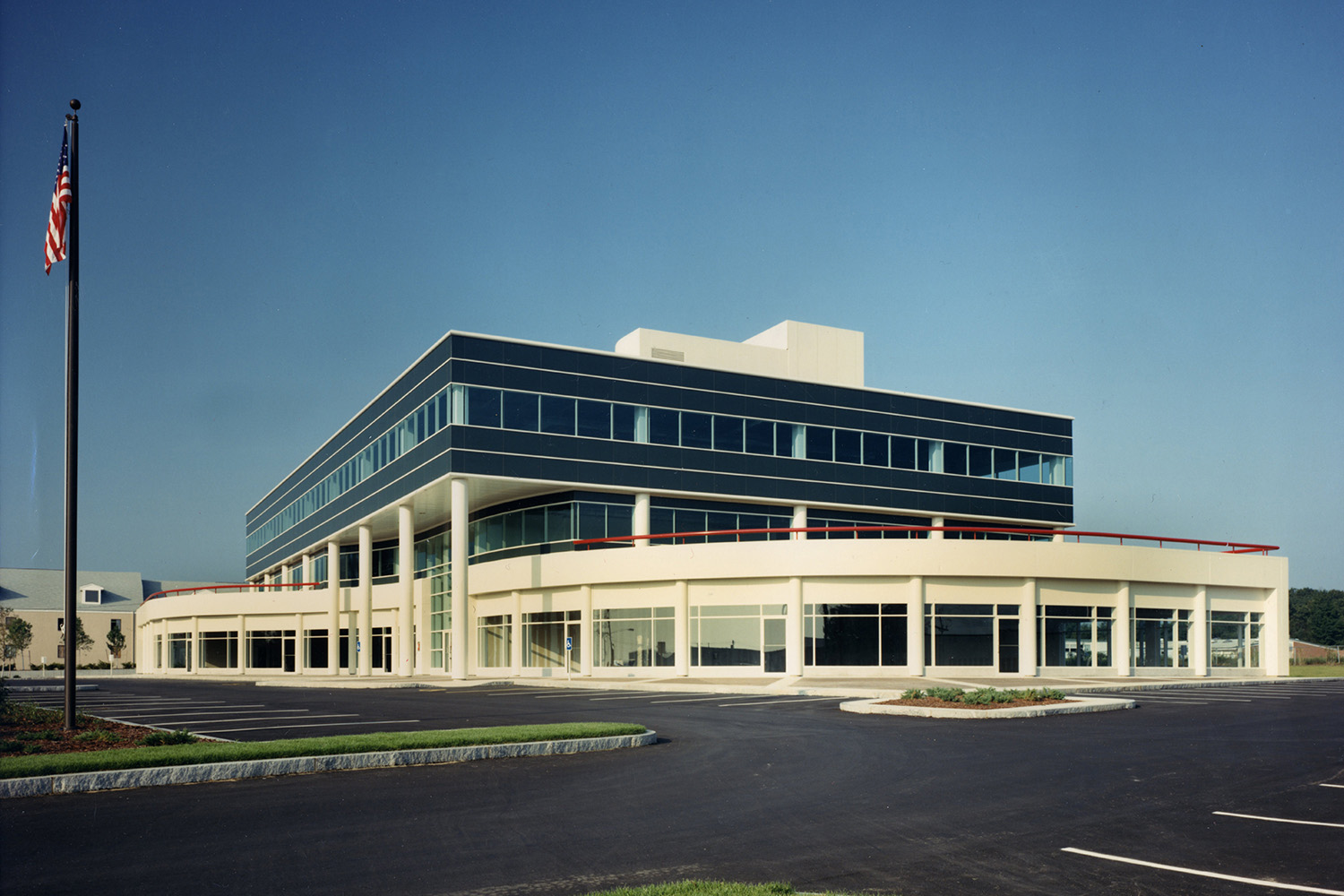 Navy blue building with white outer structure detail, seen at a distance