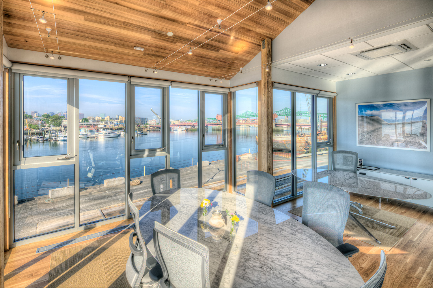 Chic conference room with wall-sized window, with scenic view of ocean outside