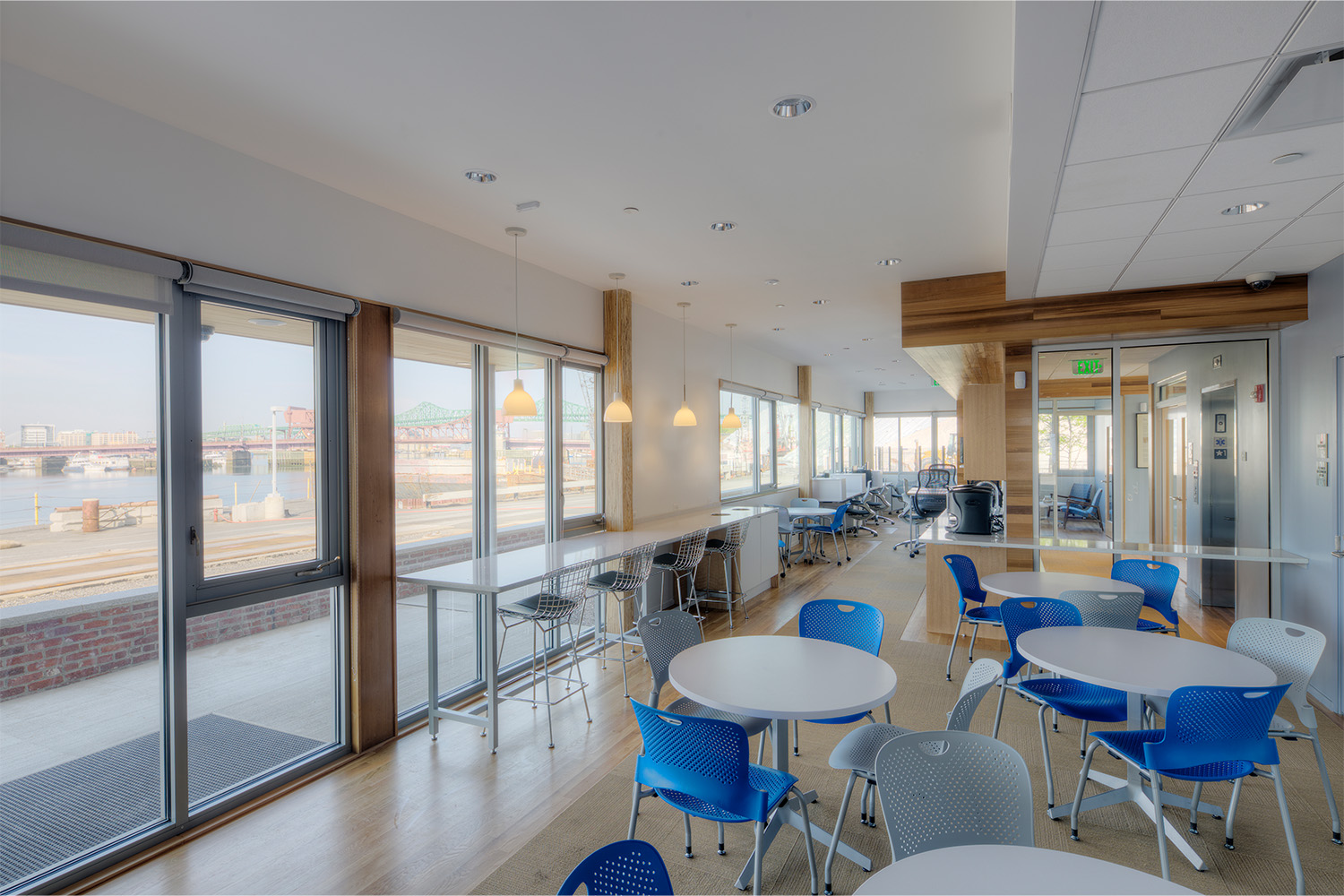 Dining area with  windows taking up entire left wall space, allowing sightseeing of the ocean right outside 