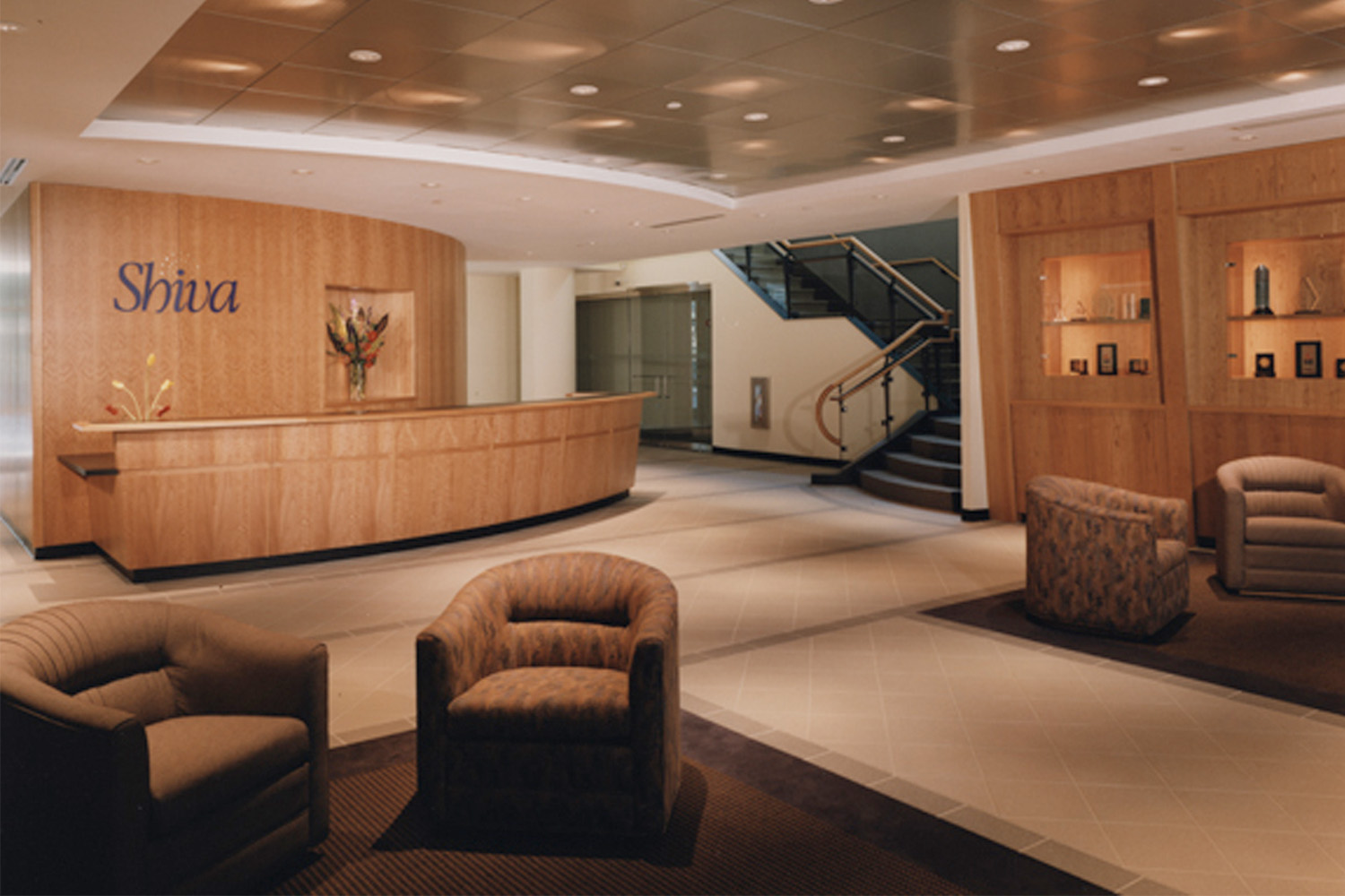 Lobby with plush seats, wooden walls, and wooden reception desk 