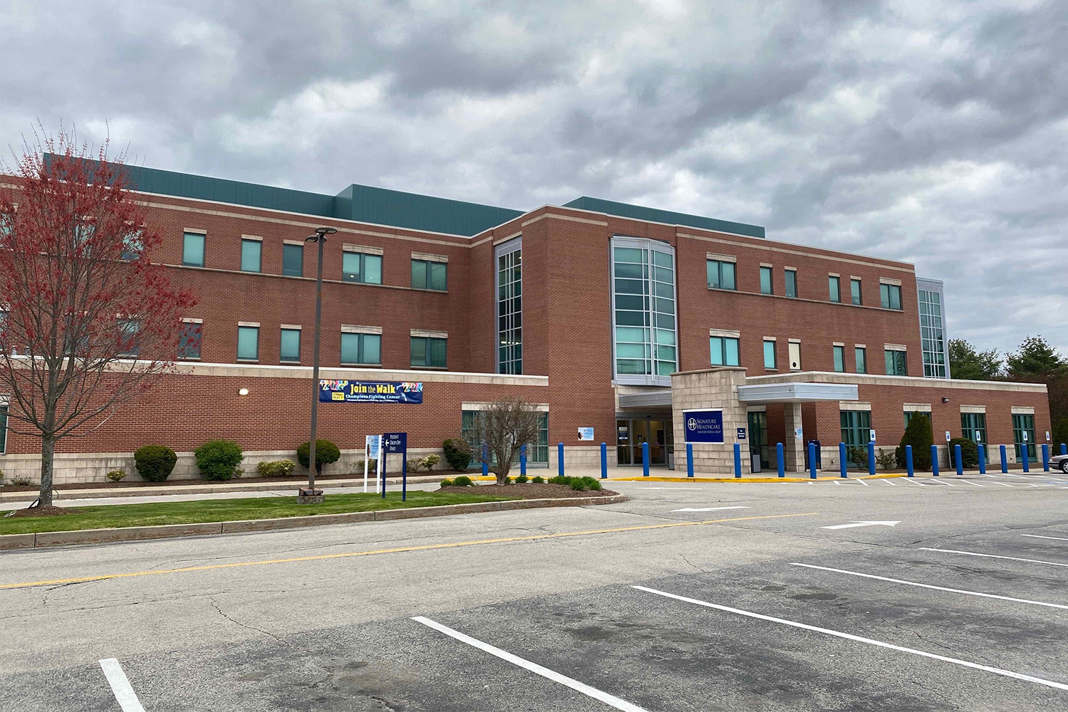Red brick building seen from across parking lot