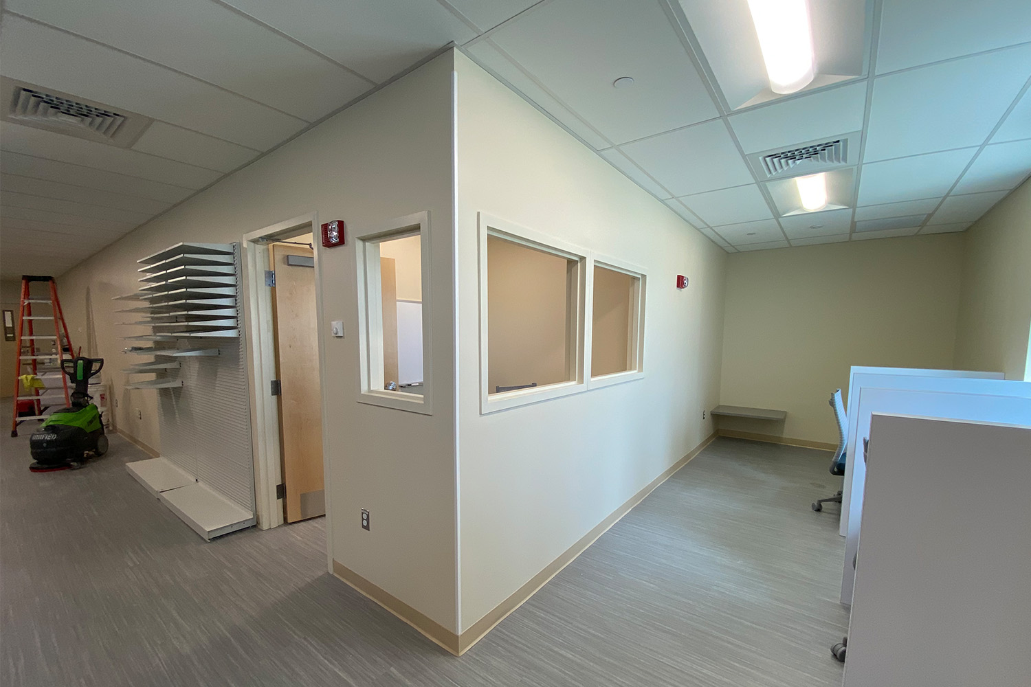 Unoccupied office space with white walls and hallway