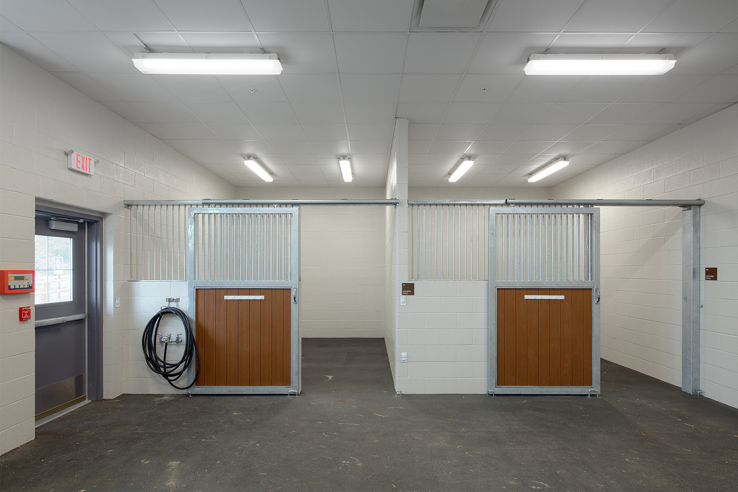 two unoccupied holding stalls for horses