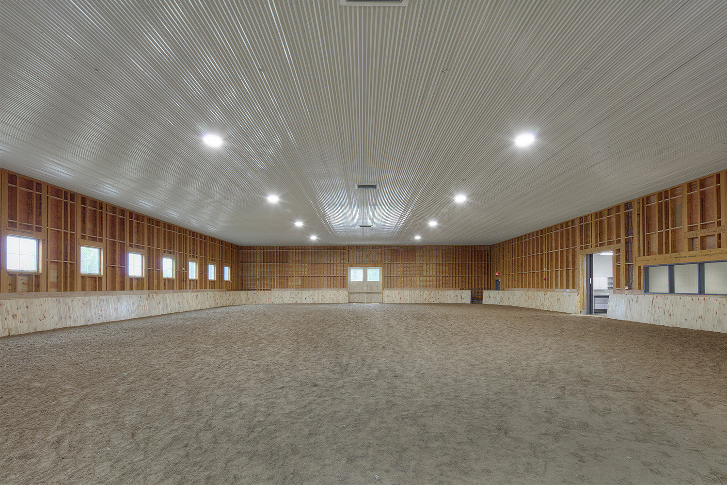 Spacious horse riding arena inside of stable