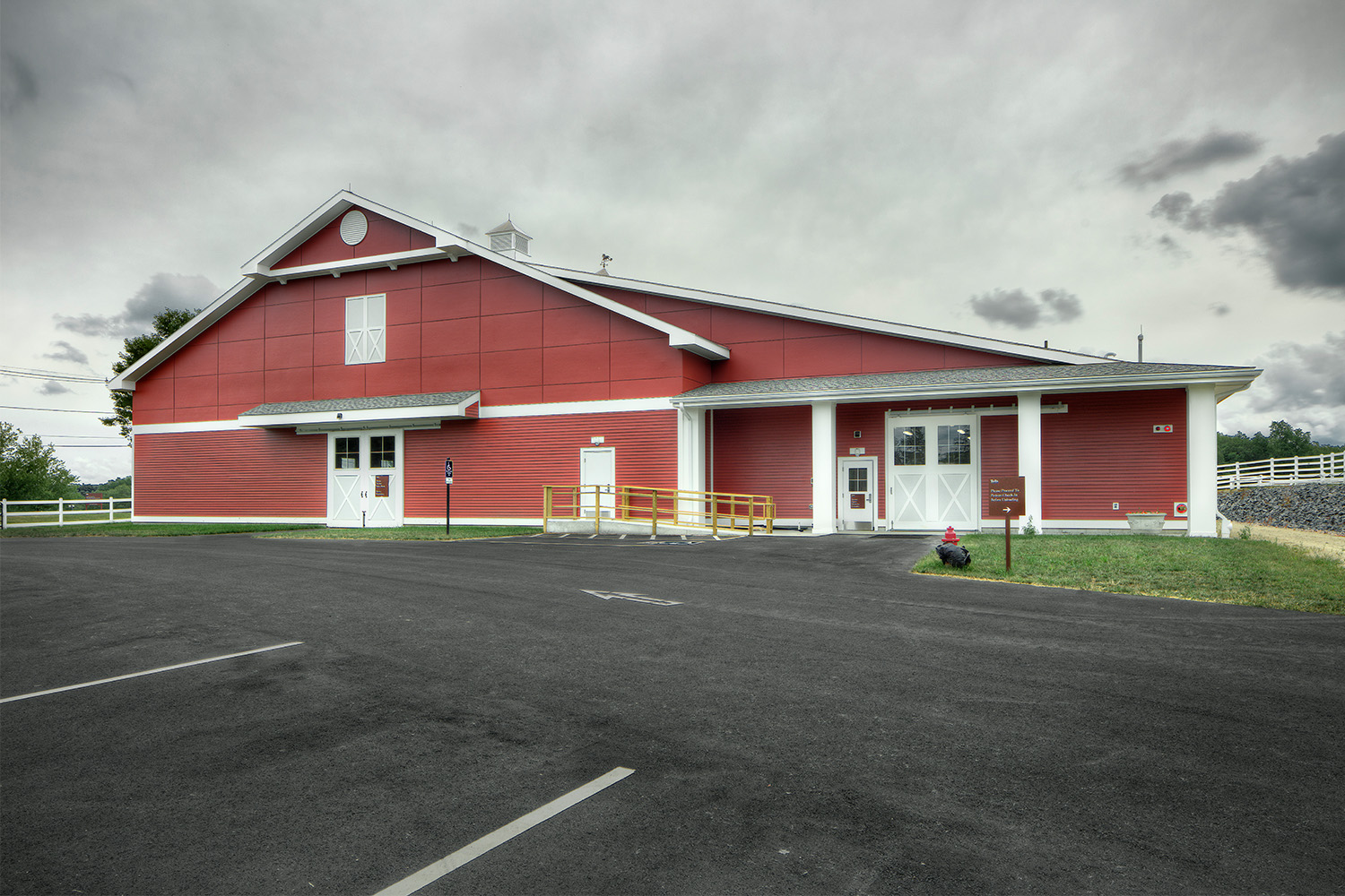 View of stable exterior, as seen from across a parking lot