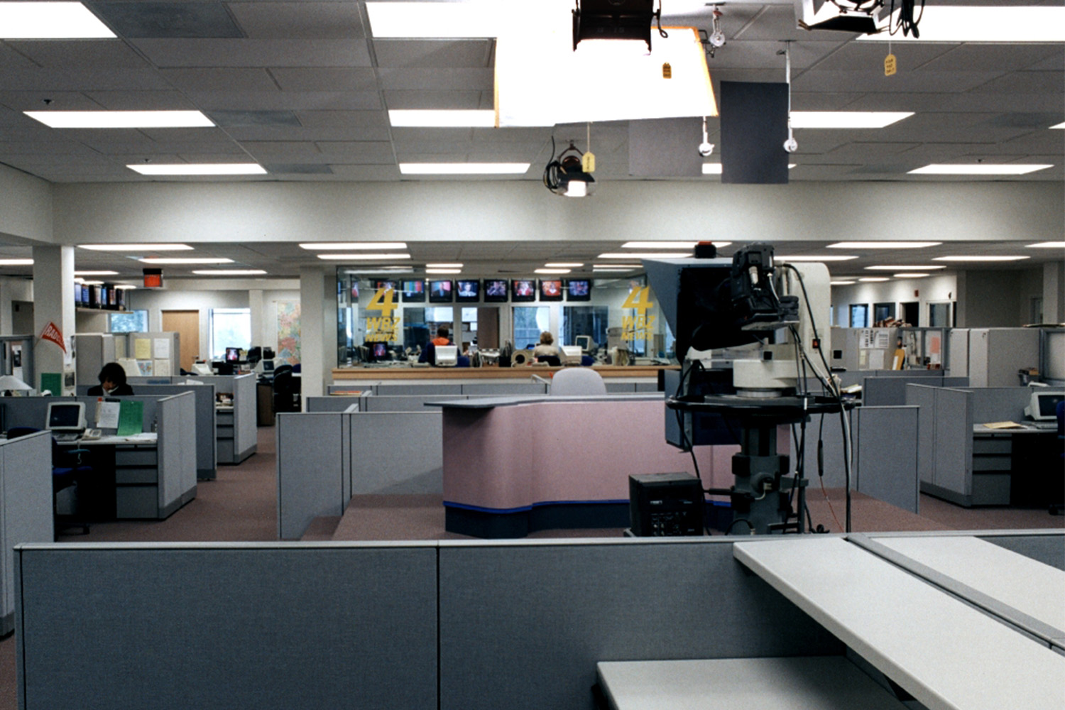 WBZ newsroom with cubicles and TV's mounted on walls 