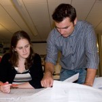 2 people overlooking paperwork 