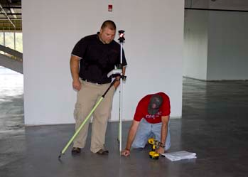 2 men working on building layout 