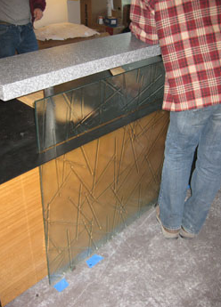 man standing in front of glass panel 