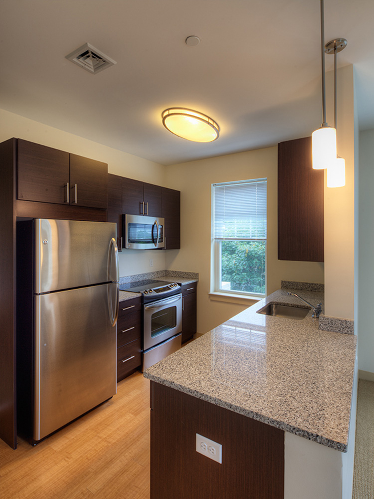 Kitchen with granite countertop and mahogany cabinets