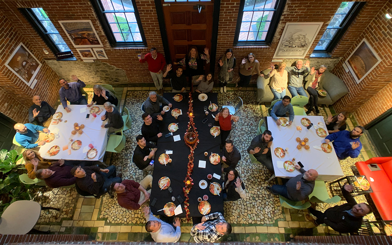 Tocci employees posing for group photo at Thanksgiving potluck