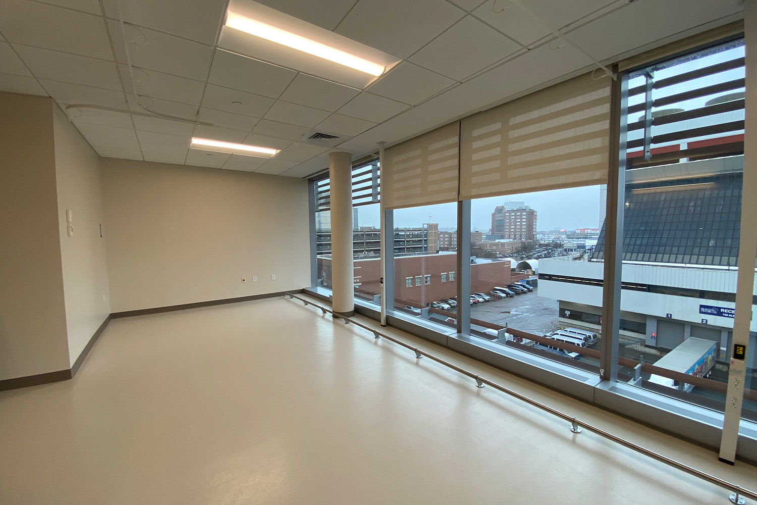 Empty examination room with large window to the right 